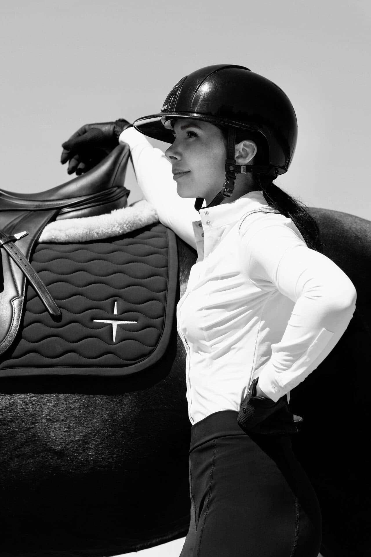 Black and white editorial portrait of Grace Kay beside her horse