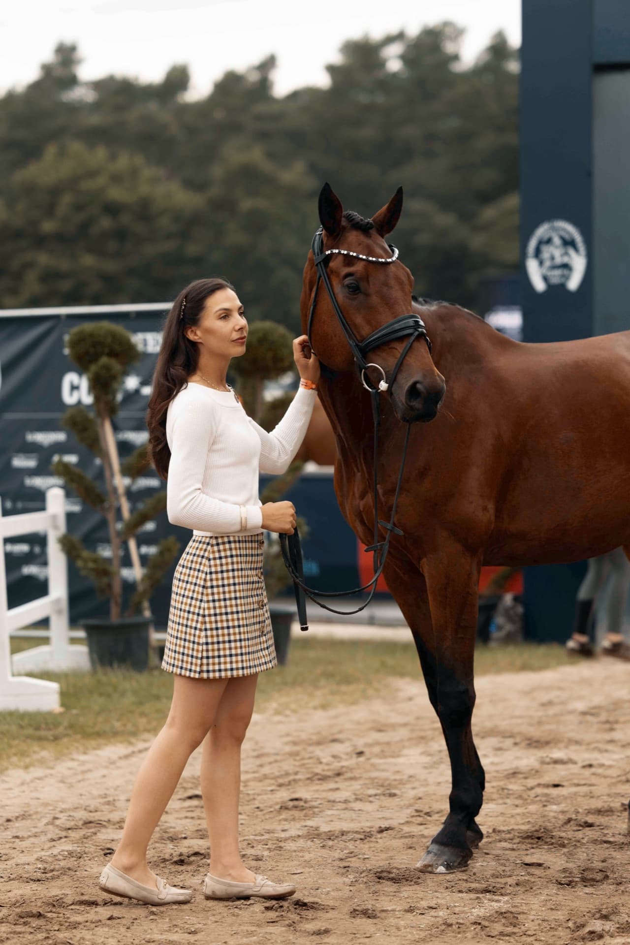Grace Kay standing with her horse