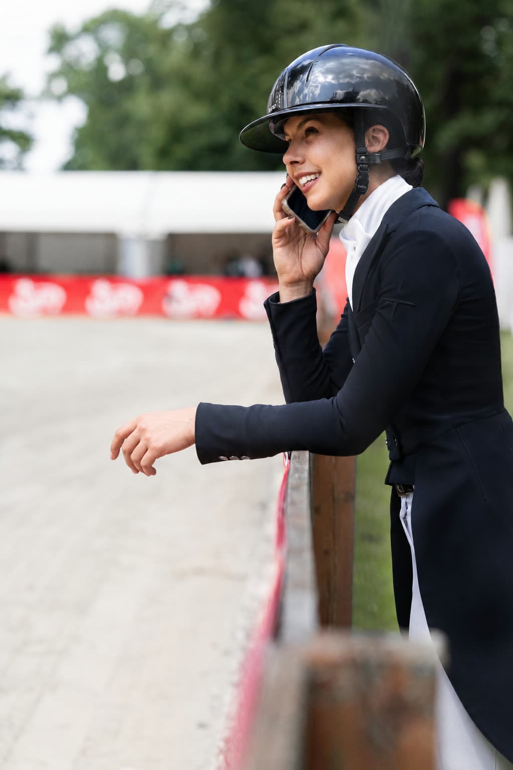 Grace Kay on the phone ringside in her competition tails